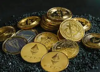 a pile of bitcoins sitting on top of a pile of gravel