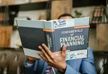 Person Reading a Book About Fundamentals of Financial Planning