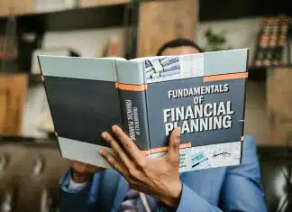 Person Reading a Book About Fundamentals of Financial Planning