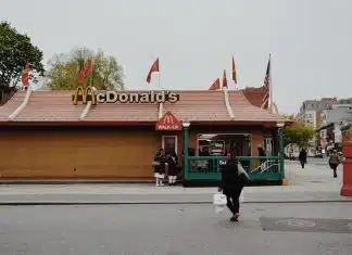 woman walking towards McDonald's branch during daytime